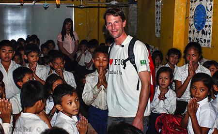 Kevin with the children in Cambodia (Photo Ian Miller)